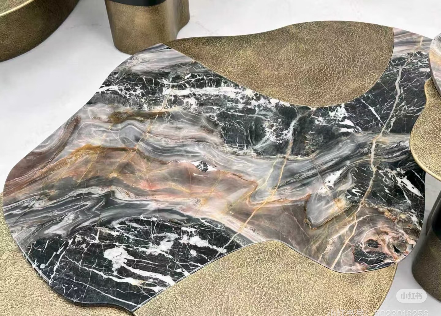 Dark marble tabletop to combined with hammered metal brass to be a unit tabletop